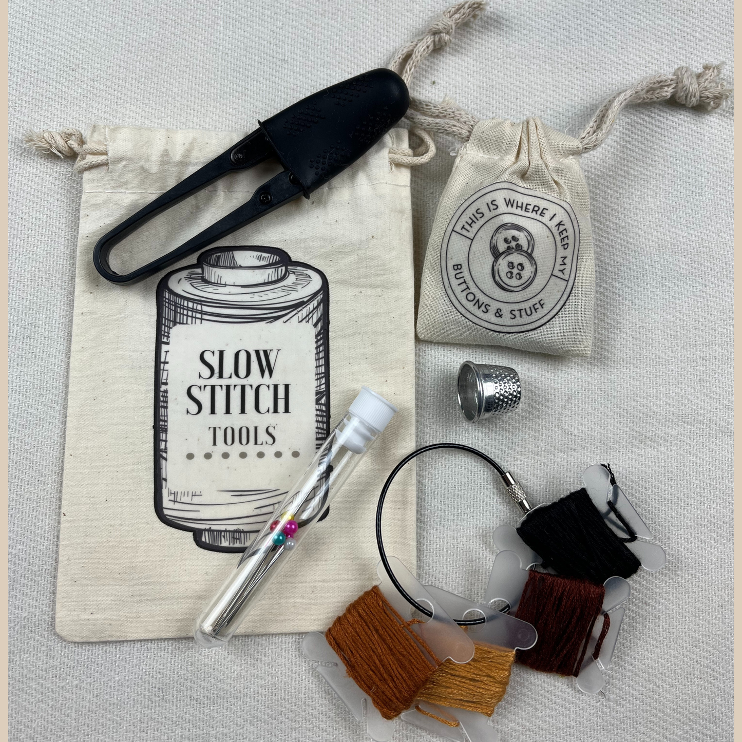 Slow Stitch Tools. Snips, thread, needles, buttons, thimble. 